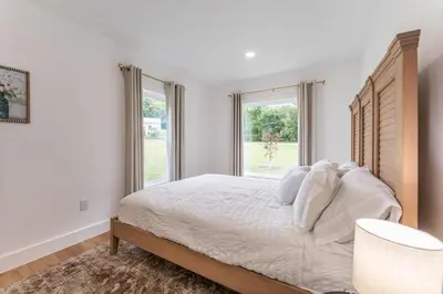 a white bedroom with a large bed and windows at Swancrest in Killbuck