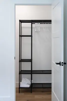 a black ladder shelf in a room with a door at Swancrest in Killbuck