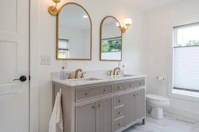 a bathroom with a sink and two mirrors at Swancrest in Killbuck