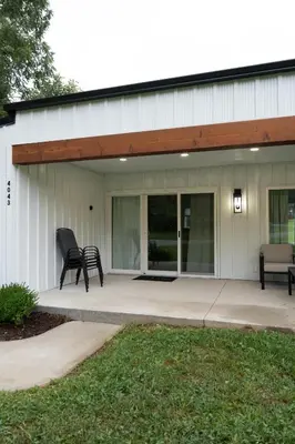 a patio with two chairs in front of a building at Swancrest in Killbuck