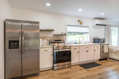a kitchen with a stainless steel refrigerator and a sink at Swancrest in Killbuck