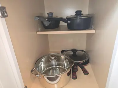 two pots and pans on a shelf in a kitchen at Townhouse at 99 in Boardman