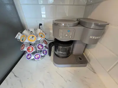a coffee maker and coffee cups in a corner at Townhouse at 99 in Boardman