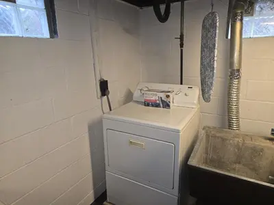 a small kitchen with a white refrigerator and a sink at Townhouse at 99 in Boardman