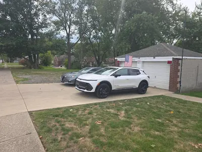 a white car parked in a driveway next to a garage at Townhouse at 99 in Boardman