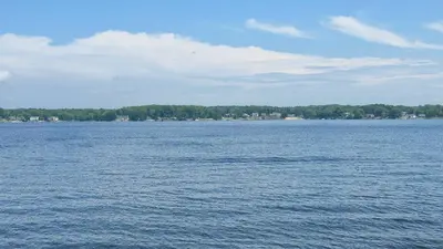 a large body of water with trees in the background at Milton's Cottage in Lake Milton