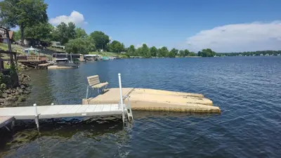 a dock in the middle of a large lake at Milton's Cottage in Lake Milton