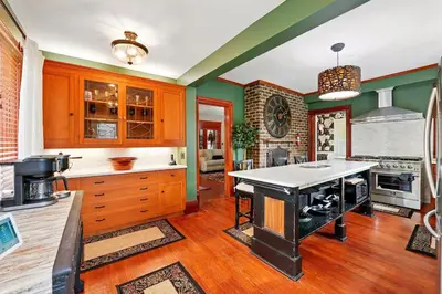 a kitchen with an island in the middle of it at The Victorian House in Canfield