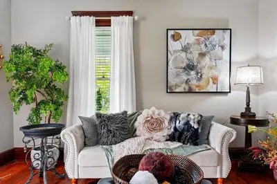 a living room with a couch and a window at The Victorian House in Canfield