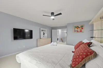 a bedroom with a white bed with a ceiling fan at Pickerington Haven - Home for 10 in Pickerington