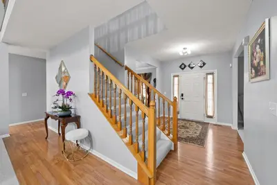 a staircase in a home with white walls and wood floors at Pickerington Haven - Home for 10 in Pickerington