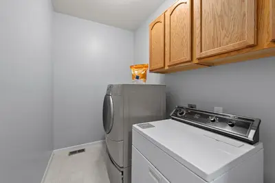 a small kitchen with a refrigerator and a dishwasher at Pickerington Haven - Home for 10 in Pickerington
