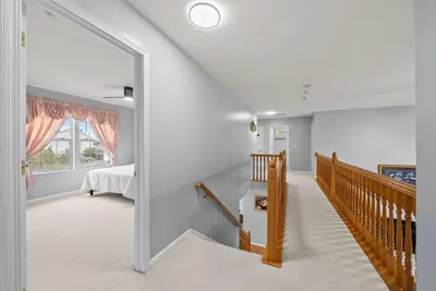 a room with a staircase and a bedroom with a bed at Pickerington Haven - Home for 10 in Pickerington