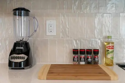 a kitchen counter with a blender and spices on a cutting board at Stunning 2 BR - Parking and Walk to Park in Columbus