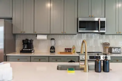 a kitchen with a sink and a microwave at Stunning 2 BR - Parking and Walk to Park in Columbus
