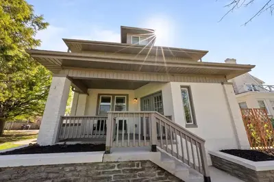 a small white house with a porch at Stunning 2 BR - Parking and Walk to Park in Columbus