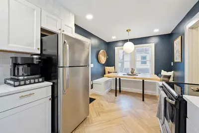 a kitchen with a stainless steel refrigerator and a table at Close to OSU Rooftop Patio Grill & Outdoor TV in Columbus
