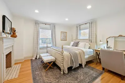 a bedroom with a bed and a desk and a fireplace at Close to OSU Rooftop Patio Grill & Outdoor TV in Columbus