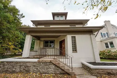 a small white house with a porch and stairs at Close to OSU Rooftop Patio Grill & Outdoor TV in Columbus