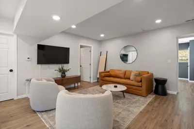 a living room with a couch and a tv at Clintonville Brand New Apartment in Columbus