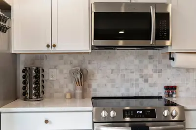 a kitchen with a stove and a microwave at Clintonville Brand New Apartment in Columbus