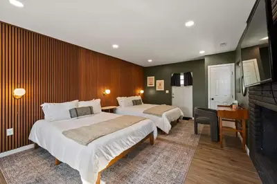 a hotel room with two beds and a fireplace at Clintonville Brand New Apartment in Columbus