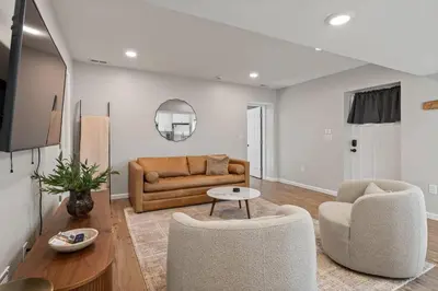 a living room with a couch and two chairs at Clintonville Brand New Apartment in Columbus