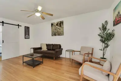 a living room with two couches and a ceiling fan at The Meadow Adventure in Columbus