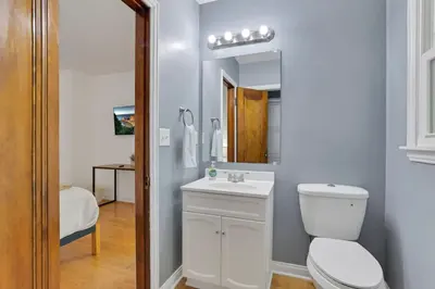 a bathroom with a toilet and a sink and a mirror at The Meadow Adventure in Columbus