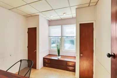 a room with a potted plant on a dresser in front of a window at The Meadow Adventure in Columbus