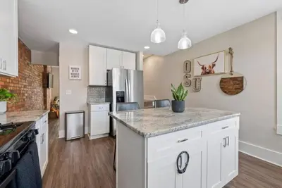 a kitchen with white cabinets and a counter top at Sophisticated Boho Condo Walkable Columbus in Columbus