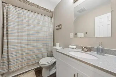 a bathroom with a toilet and a sink and a mirror at Sophisticated Boho Condo Walkable Columbus in Columbus