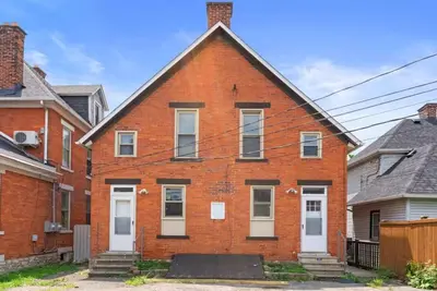 a red brick house with white doors and windows at Sophisticated Boho Condo Walkable Columbus in Columbus