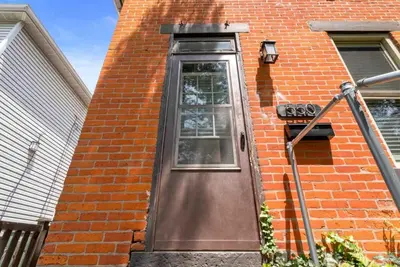 a door on a brick building with a sign on it at Sophisticated Boho Condo Walkable Columbus in Columbus