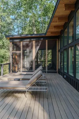 a deck with a bed on a house at The Hollow House in McArthur
