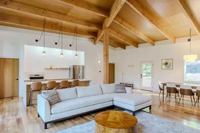 a living room with a white couch and a table at The Hollow House in McArthur