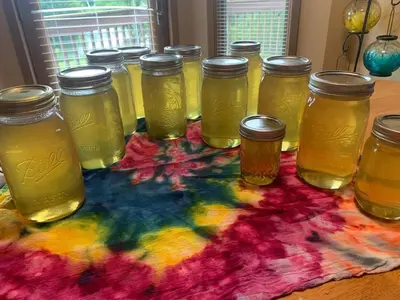 a group of jars of honey on a colorful rug at The Honey Hut Think of On Golden Pond in Mount Sterling