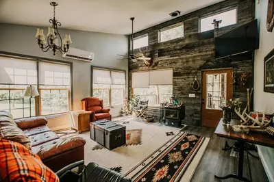 a living room with a couch and a table at The Honey Hut Think of On Golden Pond in Mount Sterling
