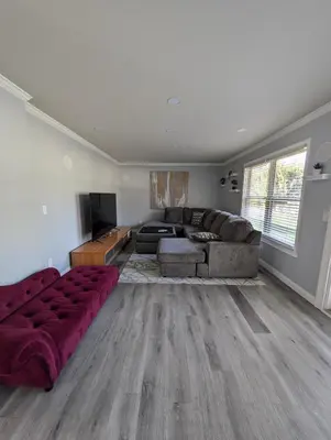 a living room with a couch and a table at CulDeSec Home 4BR 3 & half Baths Sleeps 7 Jacuzzi tub in Columbus