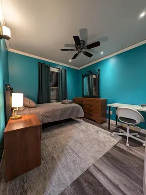 a bedroom with a bed and a ceiling fan at CulDeSec Home 4BR 3 & half Baths Sleeps 7 Jacuzzi tub in Columbus
