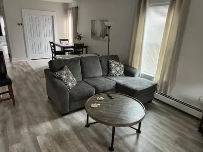 a living room with a couch and a coffee table at Gem 1 Downtown Willoughby Historic District in Willoughby