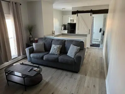 a living room with a couch and a table at Downtown Willoughby Historic District Gem 3 in Willoughby