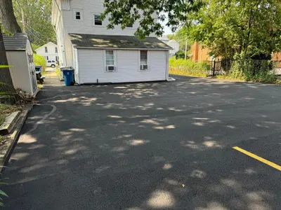 a parking lot with a house and a driveway at Downtown Willoughby Historic District Gem 3 in Willoughby