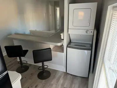 a small bathroom with a sink and two chairs at Downtown Willoughby Historic District Gem 3 in Willoughby