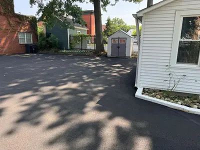 a driveway next to a house with a garage at Downtown Willoughby historical district Gem 4 in Willoughby