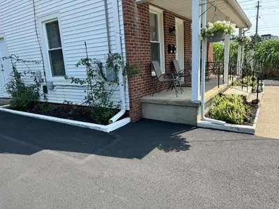 a house with two flower beds on the front porch at Downtown Willoughby historical district Gem 4 in Willoughby
