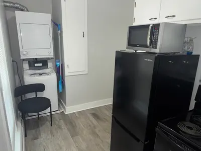 a kitchen with a black refrigerator and a computer on top of it at Downtown Willoughby historical district Gem 4 in Willoughby