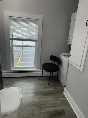a bathroom with a toilet and a window at Downtown Willoughby historical district Gem 4 in Willoughby