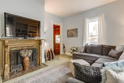 a living room with a couch and a fireplace at Walkable Group Getaway with Bikes in West Liberty! in West Liberty