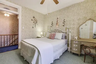 a bedroom with a bed and a mirror and a balcony at Walkable Group Getaway with Bikes in West Liberty! in West Liberty